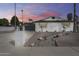 Charming single-Gathering home showcasing a white brick exterior with desert landscaping at 1716 W Butler Dr, Phoenix, AZ 85021