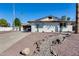 Lovely single-story home boasting white brick, desert landscaping, and a spacious driveway at 1716 W Butler Dr, Phoenix, AZ 85021