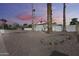 Charming home exterior showcasing its well-maintained yard with rock bed, white brick and a spacious driveway at 1716 W Butler Dr, Phoenix, AZ 85021