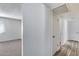 Hallway leads to a carpeted room and a white door, offering a glimpse into the home's layout at 1716 W Butler Dr, Phoenix, AZ 85021