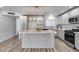 Bright eat-in kitchen featuring an island, modern cabinetry, and stainless steel appliances at 1716 W Butler Dr, Phoenix, AZ 85021
