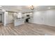 Stylish kitchen featuring stainless steel appliances, a center island, and hardwood floors at 1716 W Butler Dr, Phoenix, AZ 85021