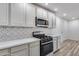 Updated kitchen with stainless steel oven and white countertops at 1716 W Butler Dr, Phoenix, AZ 85021