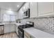 The kitchen features stainless steel appliances and decorative backsplash at 1716 W Butler Dr, Phoenix, AZ 85021