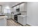 Updated kitchen with stainless steel appliances and white countertops at 1716 W Butler Dr, Phoenix, AZ 85021