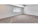 Spacious living room features plush carpet and a modern ceiling fan at 1716 W Butler Dr, Phoenix, AZ 85021