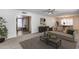 Bright living room features neutral tones, modern ceiling fan, and wood-look accent table at 1716 W Butler Dr, Phoenix, AZ 85021