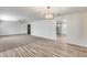 Spacious open concept living room with hardwood floors leading to a carpeted area at 1716 W Butler Dr, Phoenix, AZ 85021