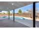 Poolside view from the covered back patio, showcasing the surrounding greenery and blue sky at 1716 W Butler Dr, Phoenix, AZ 85021