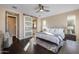 Spacious main bedroom with a king bed, sliding barn door to the bathroom, and a ceiling fan at 17670 E Fort Verde Rd, Rio Verde, AZ 85263