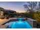 Backyard pool, spa, and patio with lounge chairs at dusk at 17670 E Fort Verde Rd, Rio Verde, AZ 85263