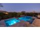 Backyard pool and spa area with lush landscaping and sunset skies at 17670 E Fort Verde Rd, Rio Verde, AZ 85263