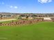 Aerial view of this vibrant community park offering playgrounds, volleyball, and green spaces for all residents at 17683 W Odeum Ln, Goodyear, AZ 85338