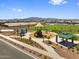 Enjoy community living with playgrounds, shaded picnic areas, and green spaces in this aerial view at 17683 W Odeum Ln, Goodyear, AZ 85338