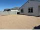 Large backyard featuring the home's exterior with bright windows and ample space for customization at 17683 W Odeum Ln, Goodyear, AZ 85338