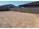 Expansive backyard enclosed by a block wall providing privacy and room for a customized outdoor space at 17683 W Odeum Ln, Goodyear, AZ 85338
