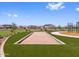 Bocce ball court on the manicured green lawn, part of community recreation and play area at 17683 W Odeum Ln, Goodyear, AZ 85338