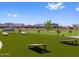 Outdoor community space featuring benches and game areas in this landscaped green space for residents at 17683 W Odeum Ln, Goodyear, AZ 85338