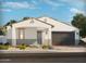 Charming single-story home with a two-car garage, desert landscaping, and a modern color palette at 17683 W Odeum Ln, Goodyear, AZ 85338