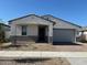 Charming single-story home with a two-car garage and low maintenance desert landscaping at 17683 W Odeum Ln, Goodyear, AZ 85338