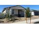 Single-story home with a two-car garage and desert landscaping, offering an inviting curb appeal at 17683 W Odeum Ln, Goodyear, AZ 85338