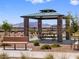 Outdoor gazebo with stone columns and a metal roof provides a shaded picnic area with seating at 17683 W Odeum Ln, Goodyear, AZ 85338