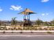 Community playground features a shaded play structure with slide and climbing area on a wood chip surface at 17683 W Odeum Ln, Goodyear, AZ 85338