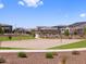 A sand volleyball court is situated within a well-maintained community park with grassy areas at 17683 W Odeum Ln, Goodyear, AZ 85338