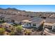 Aerial view of a home showcasing a covered patio, desert landscaping, and backyard firepit at 18961 N 259Th Ave, Buckeye, AZ 85396