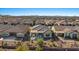 Aerial view of a home featuring a covered patio, desert landscaping, and backyard firepit at 18961 N 259Th Ave, Buckeye, AZ 85396