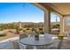 Outdoor dining on a paved patio set against a backdrop of mountain views and desert landscape at 18961 N 259Th Ave, Buckeye, AZ 85396