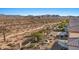 Tranquil desert backyard with native landscaping, a built-in fire pit, and mountain views at 18961 N 259Th Ave, Buckeye, AZ 85396