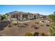 Charming desert landscaped backyard featuring a covered patio with ample seating and a built-in firepit at 18961 N 259Th Ave, Buckeye, AZ 85396