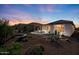 Expansive backyard with desert landscaping, fire pit, and covered patio for outdoor living at 18961 N 259Th Ave, Buckeye, AZ 85396