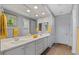 Bright bathroom with double sinks, vanity, and stylish fixtures with coordinated yellow towels at 18961 N 259Th Ave, Buckeye, AZ 85396