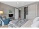 Relaxing bedroom with a soft color palette, a comfortable chair, a TV, and sliding door closet at 18961 N 259Th Ave, Buckeye, AZ 85396