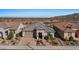 Front exterior of home features desert landscaping, brick driveway, and a tile roof at 18961 N 259Th Ave, Buckeye, AZ 85396