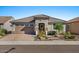 Charming front exterior features desert landscaping, brick pavers and attached garage at 18961 N 259Th Ave, Buckeye, AZ 85396