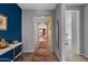 Bright hallway with hard wood floors and colorful accents leading to the various rooms at 18961 N 259Th Ave, Buckeye, AZ 85396