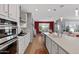 Well-equipped kitchen featuring a center island, stainless steel appliances, and dining area at 18961 N 259Th Ave, Buckeye, AZ 85396