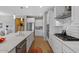 Modern kitchen showcasing white cabinetry, stainless steel appliances, and a functional layout at 18961 N 259Th Ave, Buckeye, AZ 85396