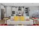 Stylish living room featuring a white sofa with vibrant pillows and an open view to the modern kitchen at 18961 N 259Th Ave, Buckeye, AZ 85396