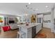 Open-concept living area with a modern kitchen, stainless steel appliances, and stylish decor at 18961 N 259Th Ave, Buckeye, AZ 85396