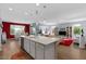 Bright living space featuring a kitchen island with seating and an inviting living area at 18961 N 259Th Ave, Buckeye, AZ 85396