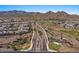 Scenic street view of a neighborhood with lush landscaping, leading to mountain views at 18961 N 259Th Ave, Buckeye, AZ 85396