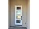 Modern front door with decorative glass panels and a digital keypad entry system at 19333 W Valle Vista Way, Litchfield Park, AZ 85340