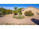 Landscaped backyard featuring desert plants, gravel, a covered patio, and desert landscaping at 19824 N Valencia Ct, Surprise, AZ 85374