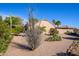 Expansive backyard showcases desert flora and residence exterior at 19824 N Valencia Ct, Surprise, AZ 85374