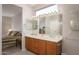 Bathroom featuring a double sink vanity, large mirror, and neutral color scheme at 19824 N Valencia Ct, Surprise, AZ 85374