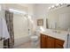 Bright bathroom features a single vanity, tiled floors, and shower over tub at 19824 N Valencia Ct, Surprise, AZ 85374
